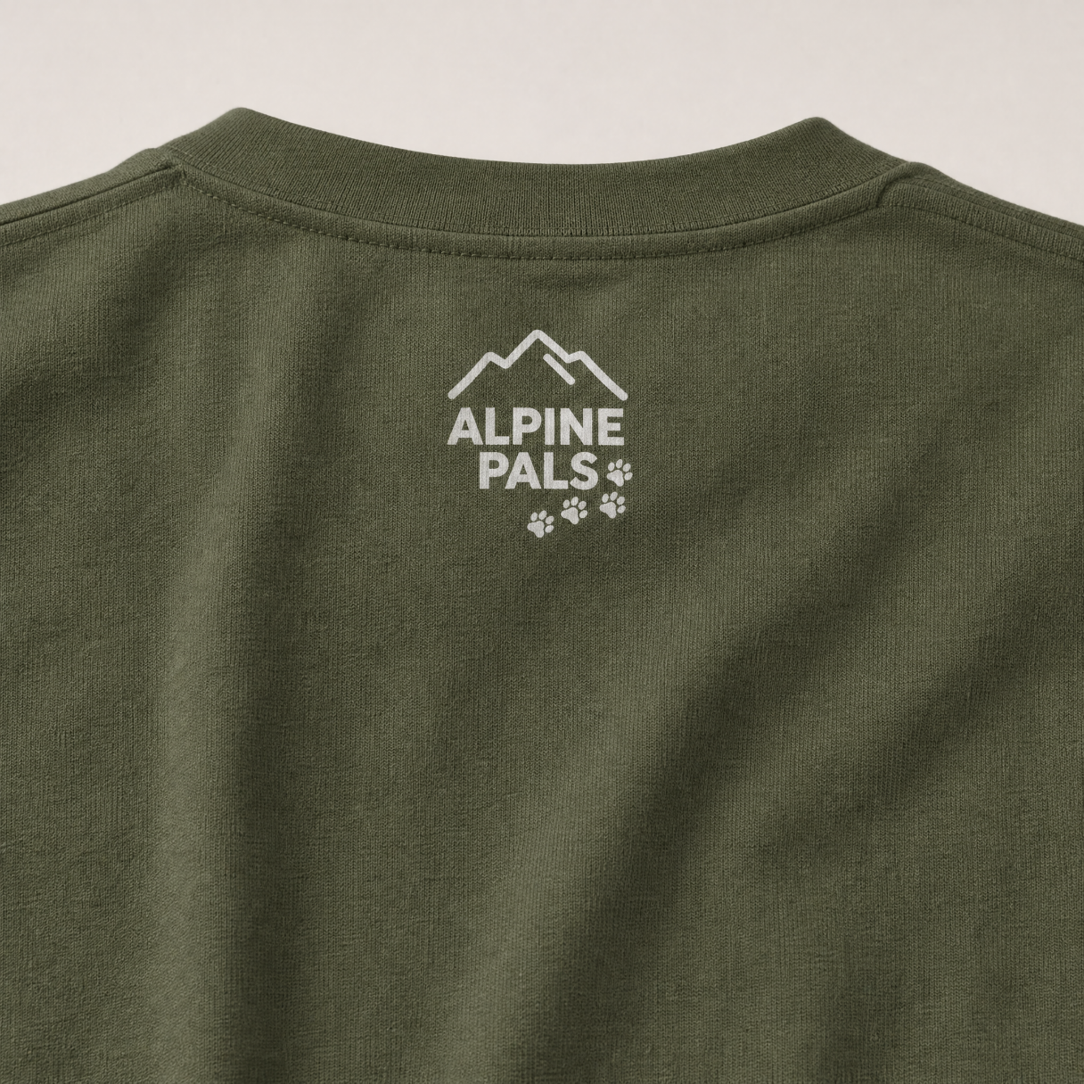 Hemp colored shirt with 'Alpine Pals' logo on a plain background