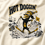 T-shirt with a cartoon dog skiing and text 'HOT DOGGIN'' on a white background