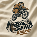 Ivory colored fabric with a bear riding a bike and 'Big Send Energy' text design.