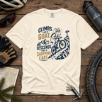 Ivory colored t-shirt with graphic design and text on a wooden surface with cycling accessories.