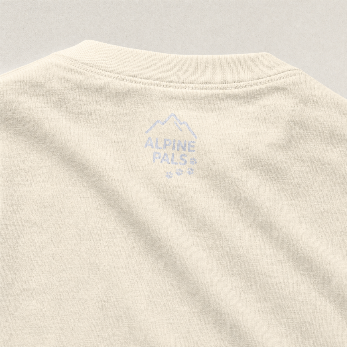 Beige fabric with 'Alpine Pals' logo on a gray background