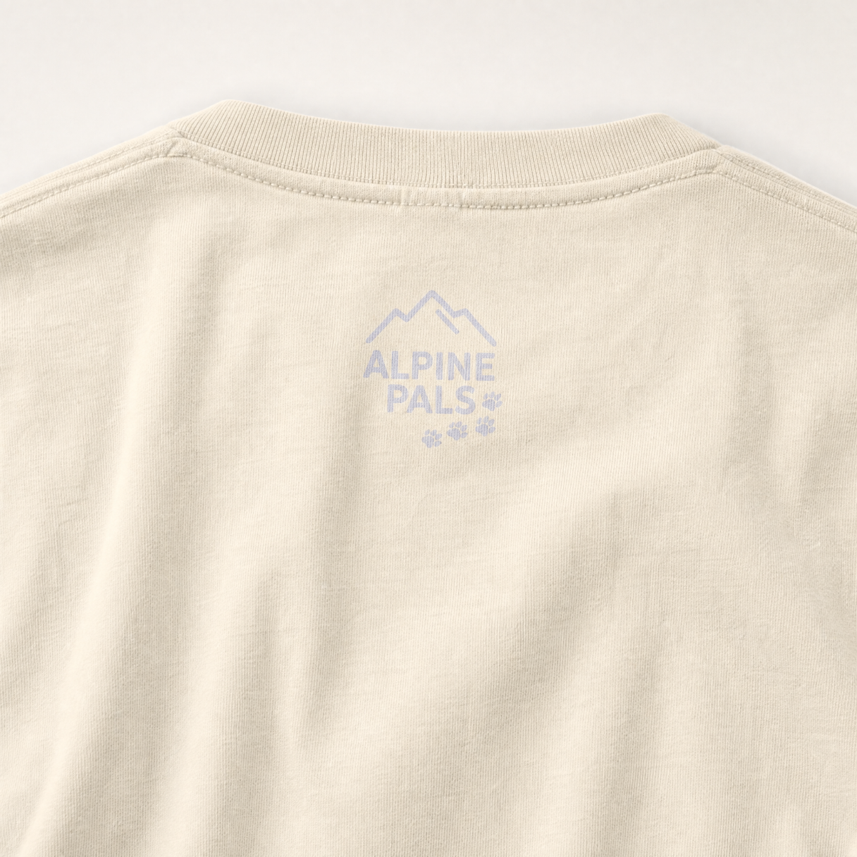 Ivory colored fabric with 'Alpine Pals' logo embroidered on a white background