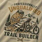 T-shirt design with a beaver character and text 'Professionally Unqualified Trail Builder' on a beige background.