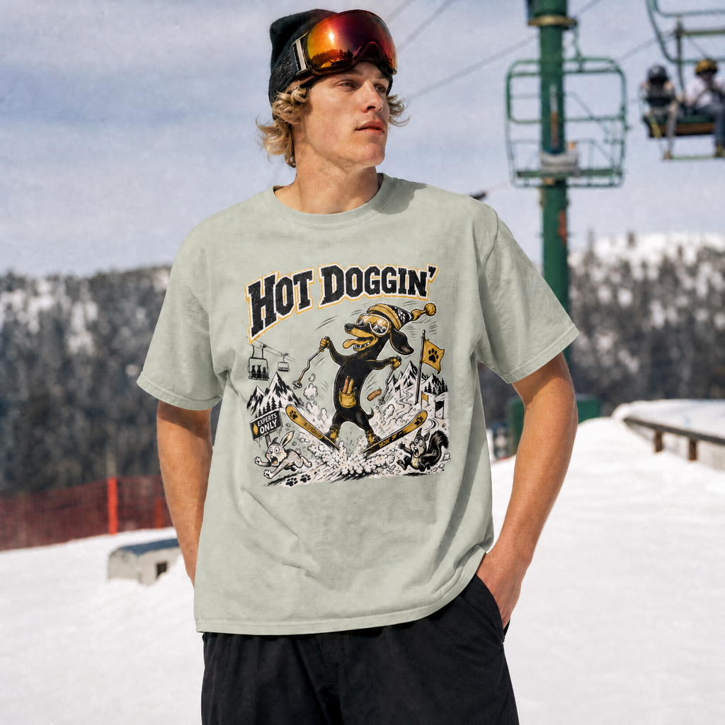 Person wearing a t-shirt with 'Hot Doggin' graphic design in a snowy outdoor setting