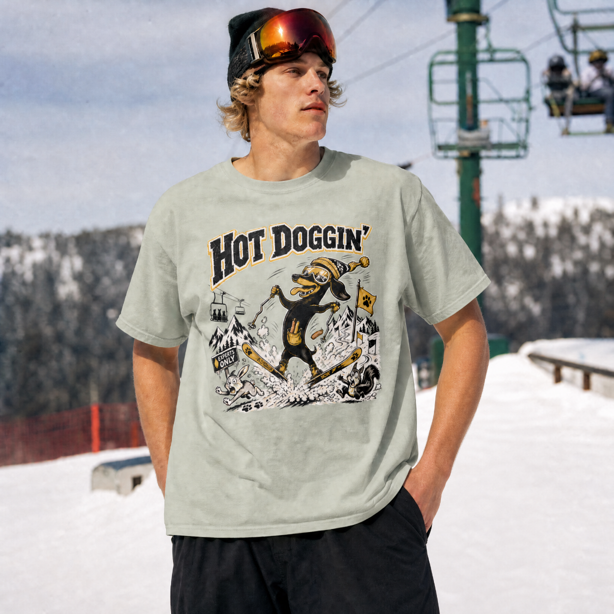 Person wearing a t-shirt with 'Hot Doggin' graphic design in a snowy outdoor setting