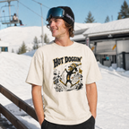 Person wearing a 'Hot Doggin' t-shirt with a snowy background