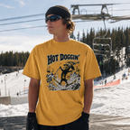 Person wearing a yellow t-shirt with 'Hot Doggin' graphic design at a ski resort.