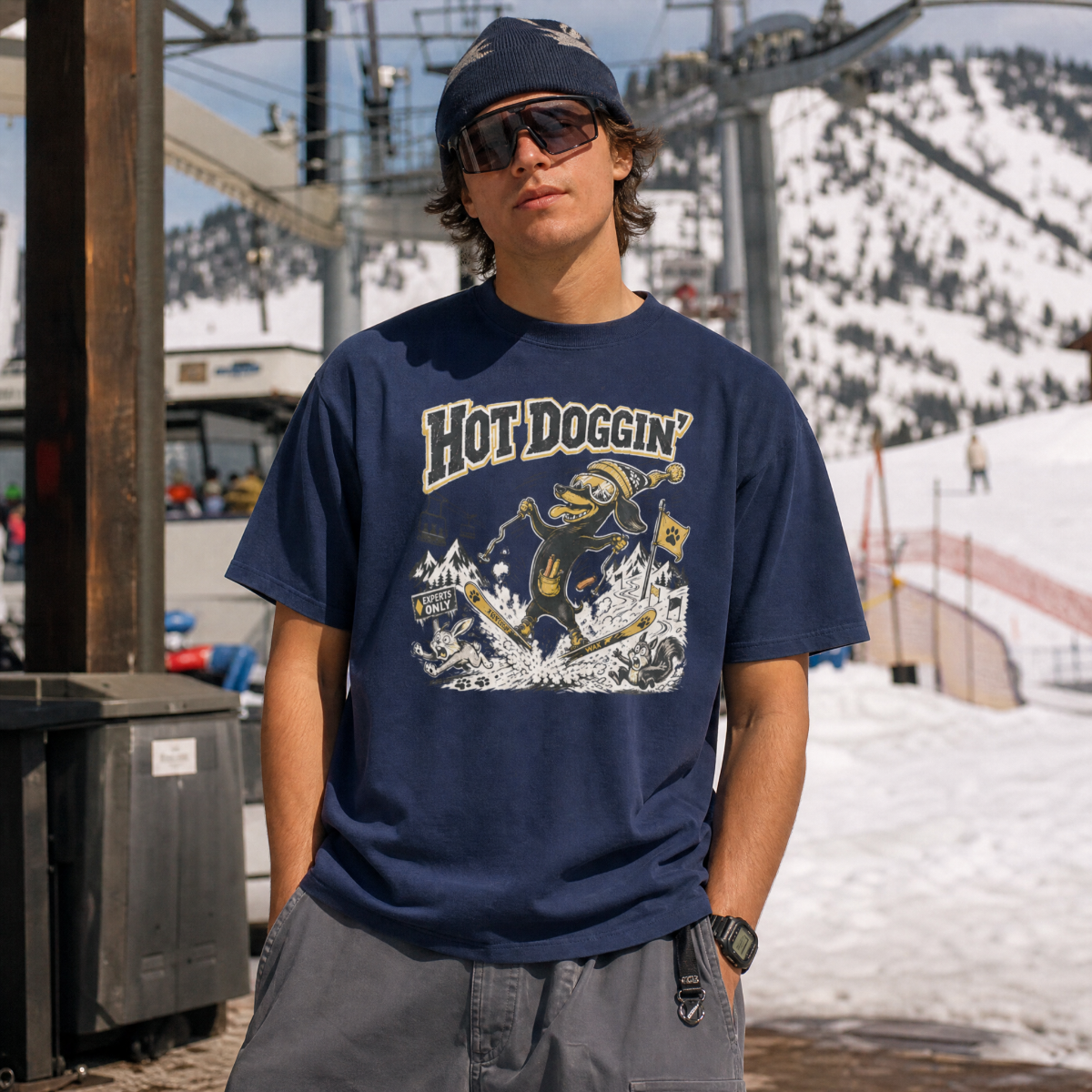 Person wearing a navy blue t-shirt with 'Hot Doggin' graphic design in an outdoor setting.