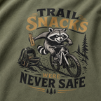 T-shirt with a raccoon graphic and 'Trail Snacks Were Never Safe' text on a green background