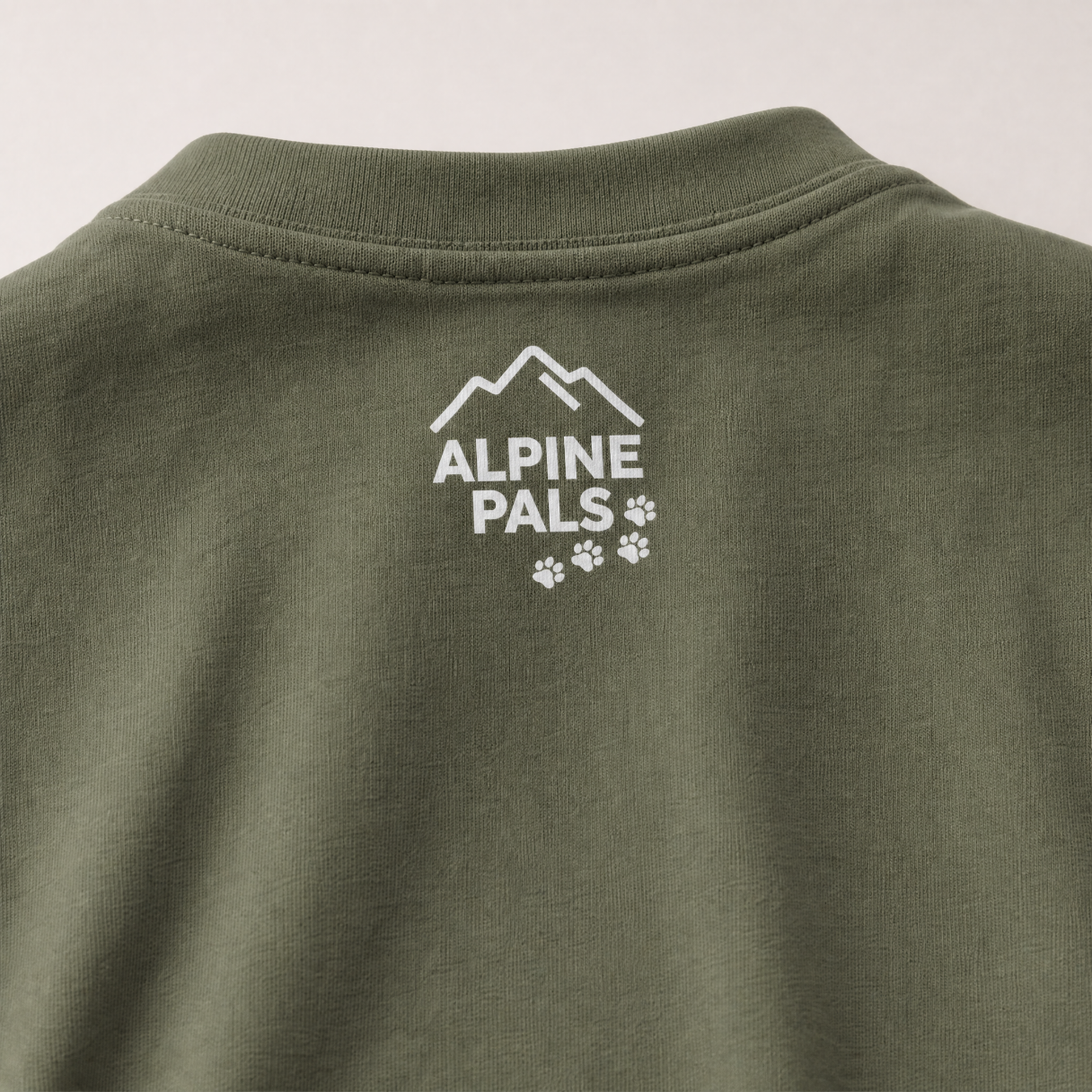 Moss green shirt with 'Alpine Pals' logo on a white background