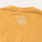 Yellow t-shirt with 'Alpine Pals' logo on a white background