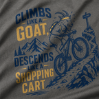 T-shirt with graphic of a goat riding a bike and text 'Climbs like a goat, descends like a shopping cart' on a gray background.