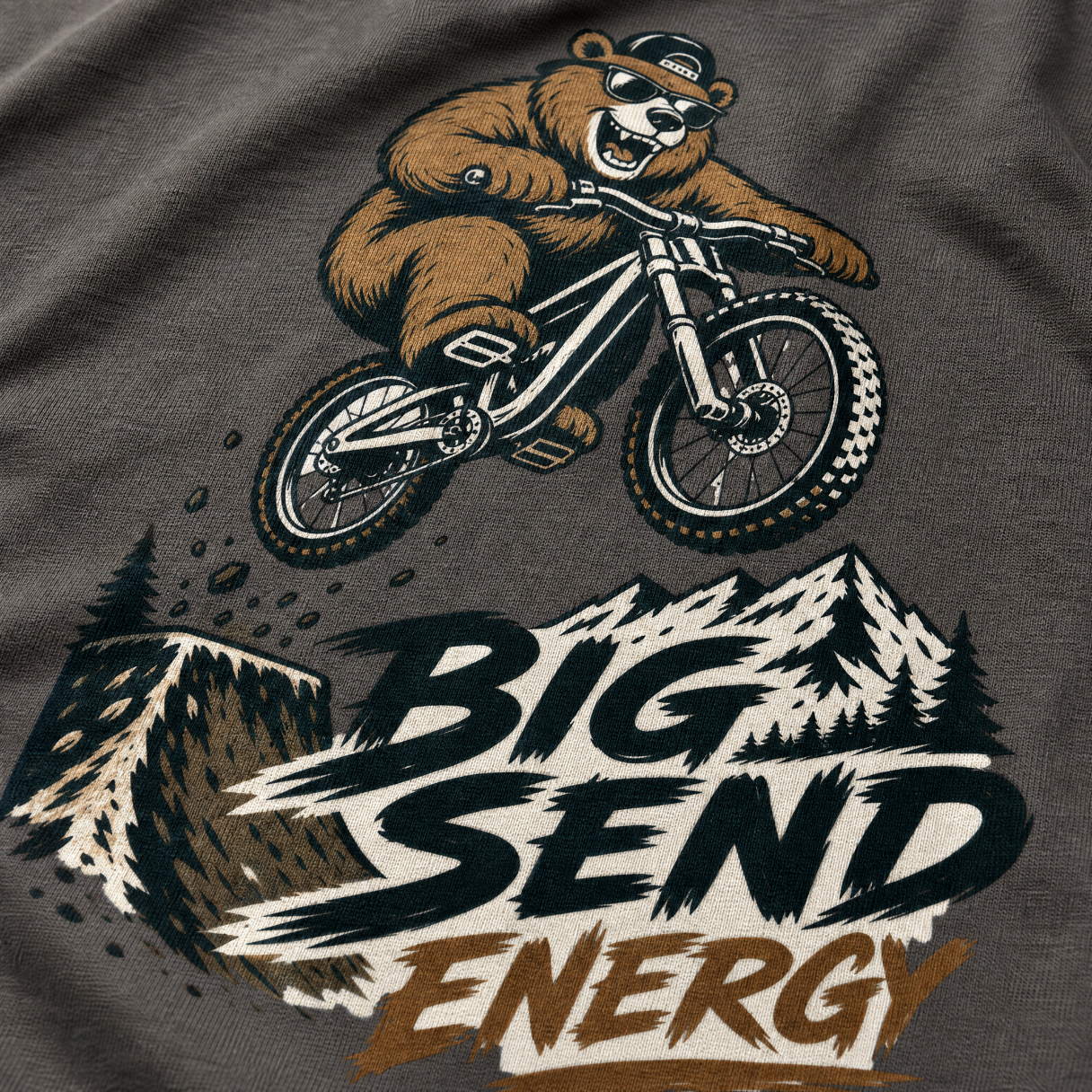 T-shirt with a bear riding a bike and 'Big Send Energy' text on a dark gray background