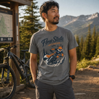 Man wearing a 'Flow State Activated' t-shirt in a mountainous outdoor setting with a bike and map in the background.