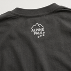 Black t-shirt with Alpine Pals logo on a gray background