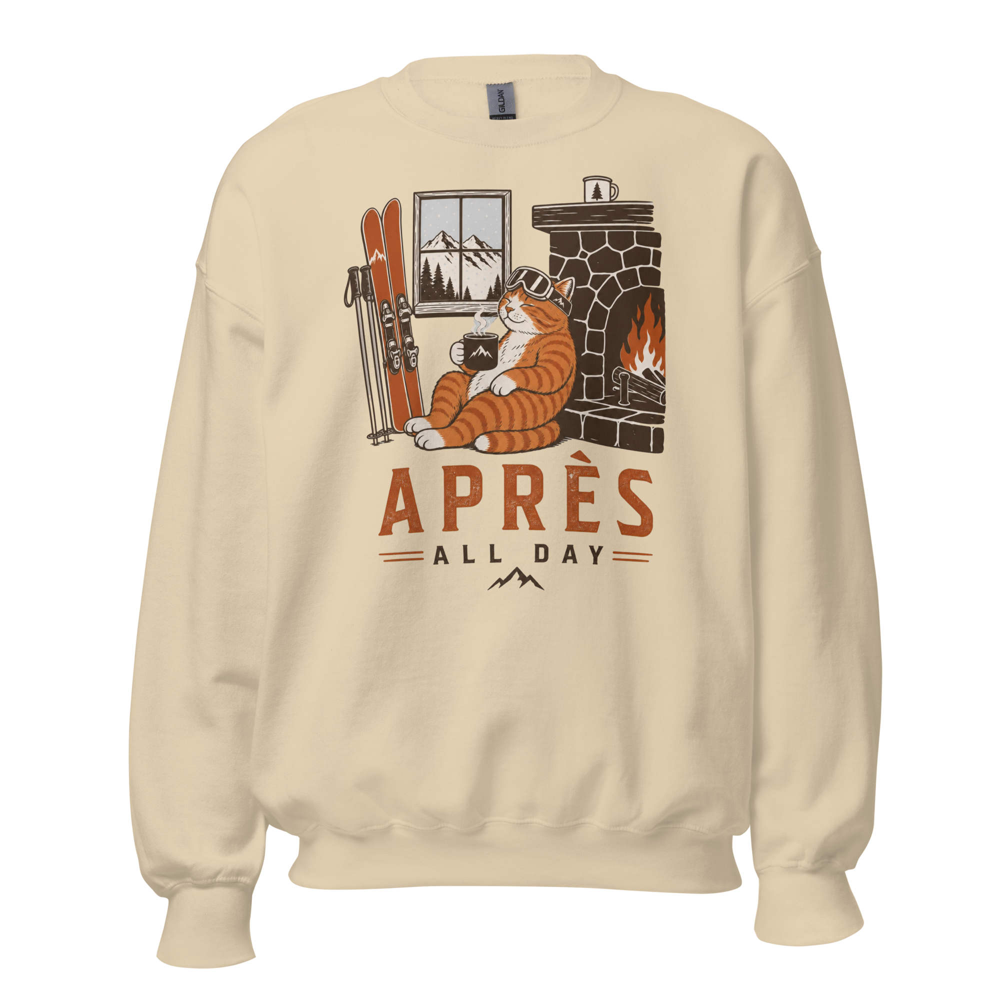 Sand colored sweatshirt with a graphic of a cat by a fireplace and skis, with 'APRES ALL DAY' text.