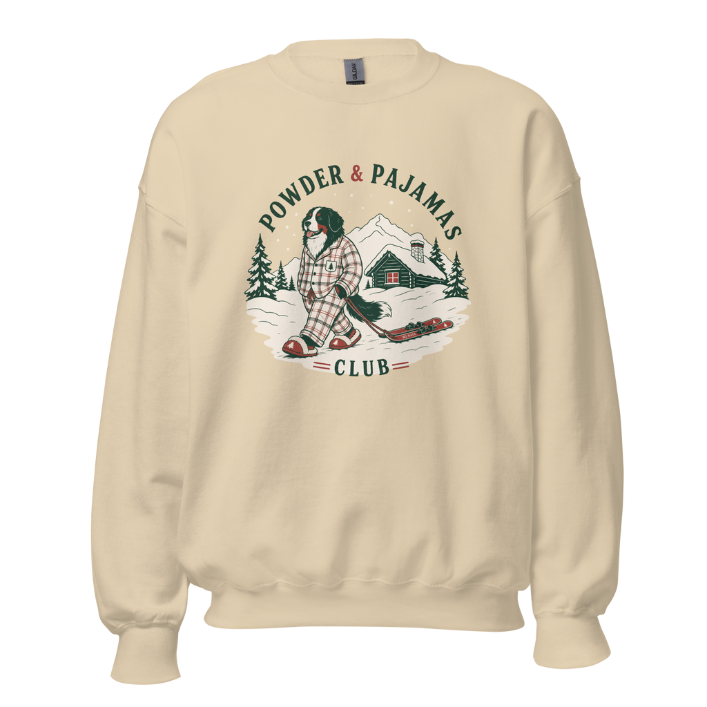 Sand colored sweatshirt with a graphic of a person in plaid pajamas and skis, with 'Powder & Pajamas Club' text.