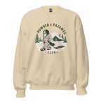 Sand colored sweatshirt with a graphic of a person in plaid pajamas and skis, with 'Powder & Pajamas Club' text.