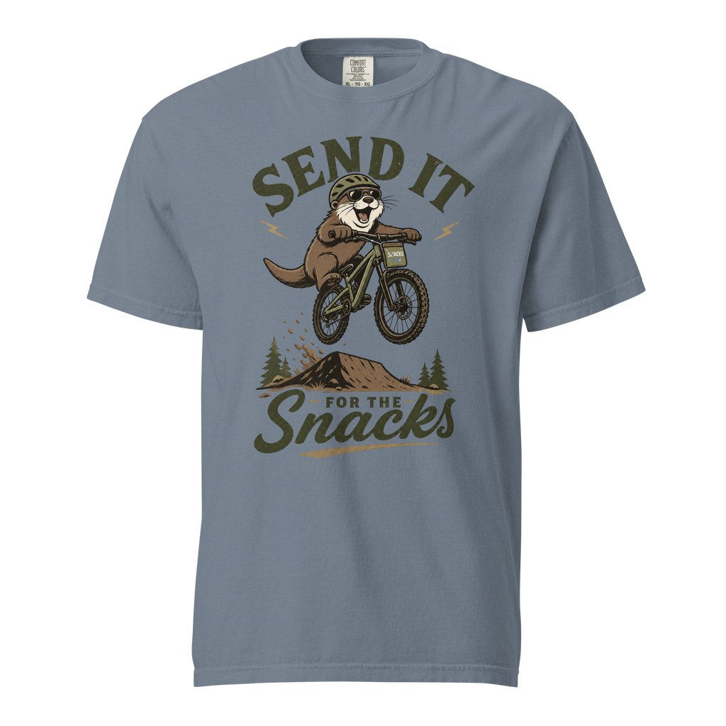 Blue jean colored t-shirt with an otter on a bike graphic and text 'Send it for the snacks'.