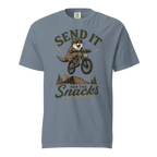 Blue jean colored t-shirt with an otter on a bike graphic and text 'Send it for the snacks'.