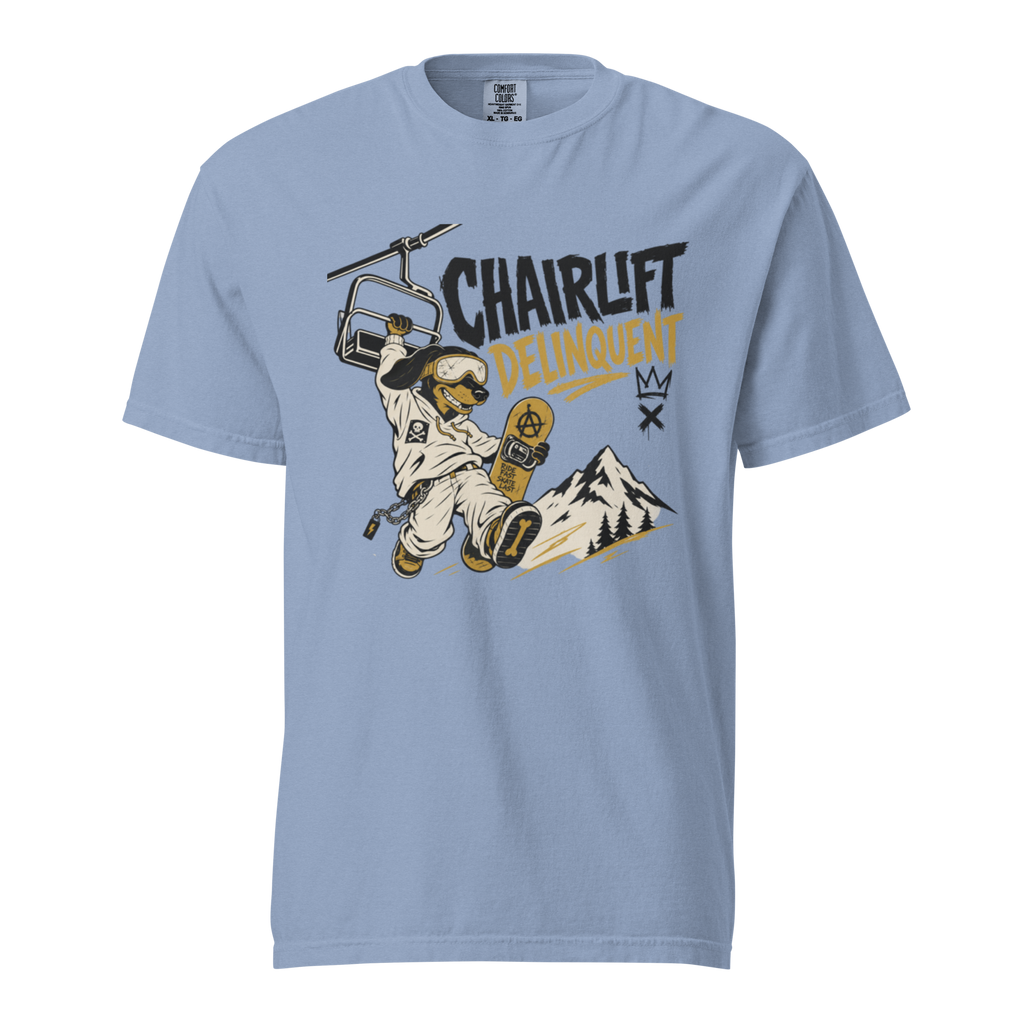 Washed denim blue t-shirt with a graphic of a skier on a chairlift and mountain, with text 'Chairlift Delinquent'.